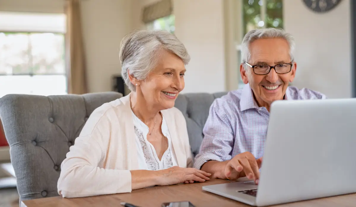 Senior couple reviewing final expense plan online to secure affordable coverage and peace of mind for family.