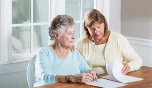 Senior parent and adult daughter reviewing final expense insurance myths and planning documents together.